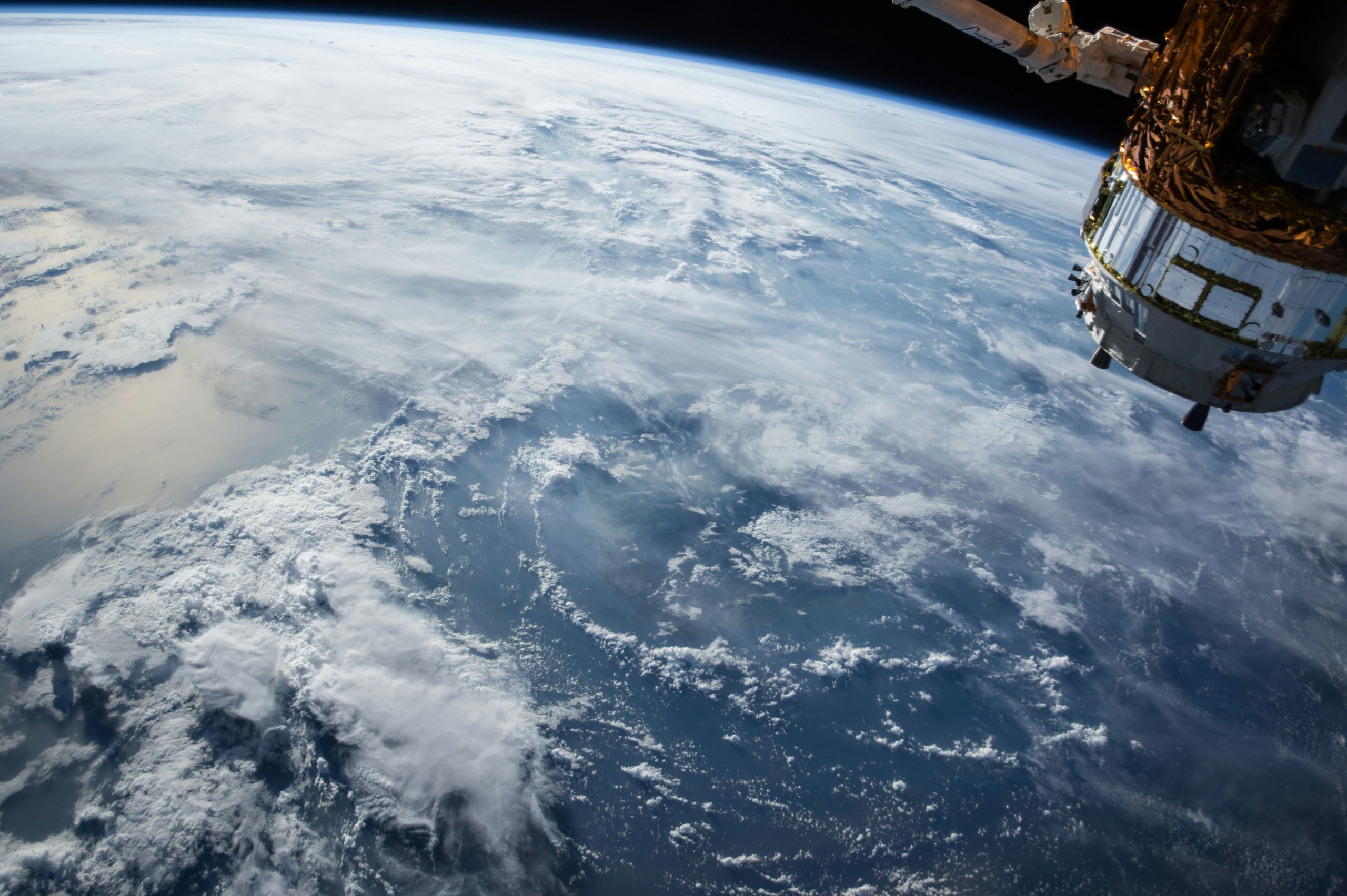 he vastness of space with the silhouette of the James Webb Telescope in the foreground, pointing towards distant stars and galaxies, highlighting its role in discovering molecules associated with life.